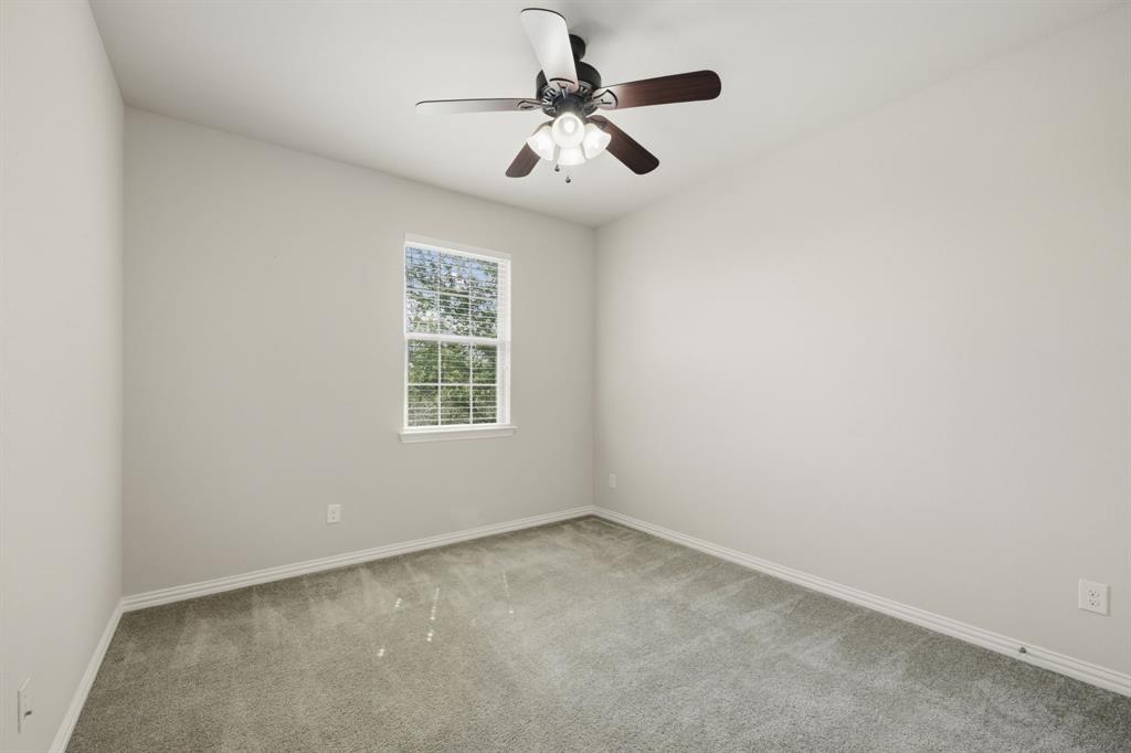12809 Spring Hill Drive Frisco, TX 75035 - Photo 33 of 37 an empty room with windows and fan