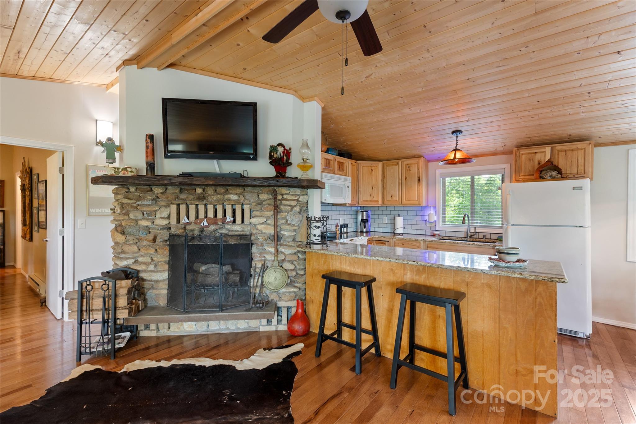 56 Faraway Drive Cullowhee, NC 28723 - Photo 13 of 46 a kitchen with a table chairs refrigerator and a fireplace