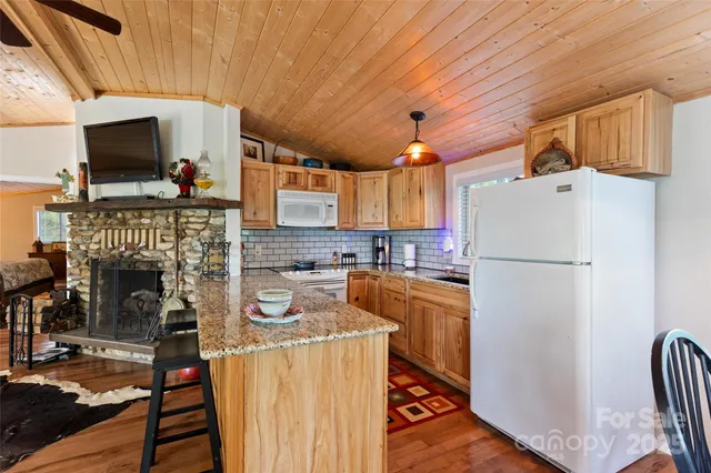 a kitchen with stainless steel appliances granite countertop a sink and cabinets
