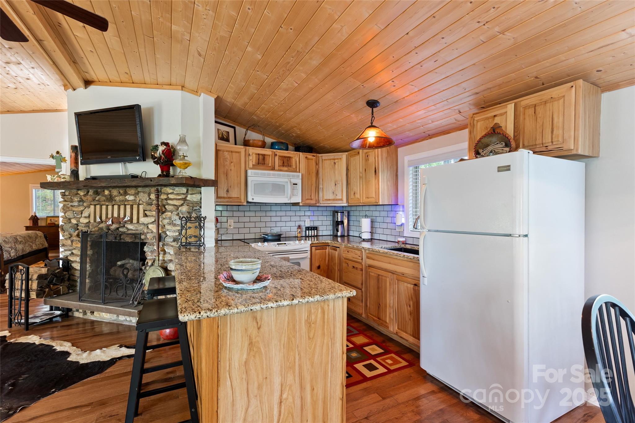 56 Faraway Drive Cullowhee, NC 28723 - Photo 16 of 46 a kitchen with a refrigerator a stove top oven a sink dishwasher and wooden floor
