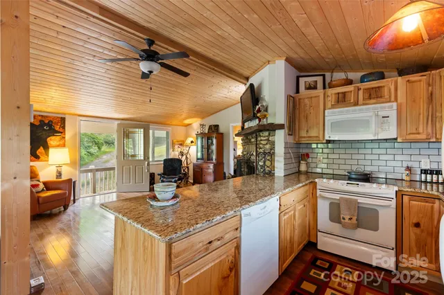 a kitchen with sink and view of living room