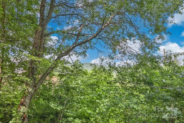 a view of a deck with two chairs and wooden fence