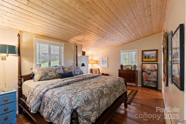 a bed room with a bed and a refrigerator