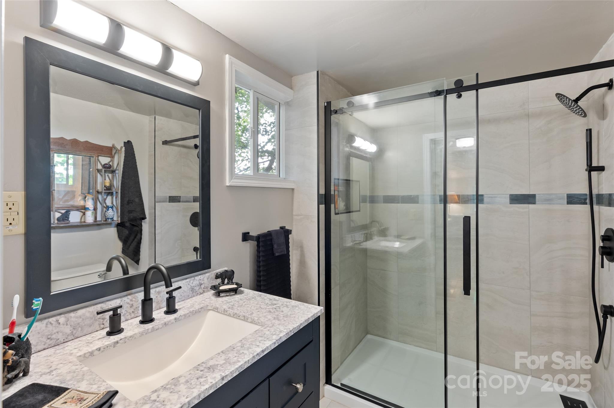 56 Faraway Drive Cullowhee, NC 28723 - Photo 34 of 46 a bathroom with a sink vanity granite shower and a mirror