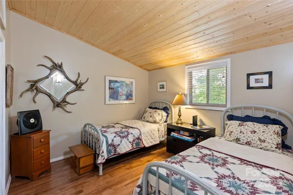 a bedroom with a bed and a mirror