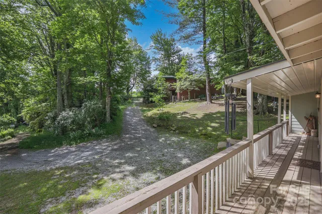 a view of a wooden deck and backyard