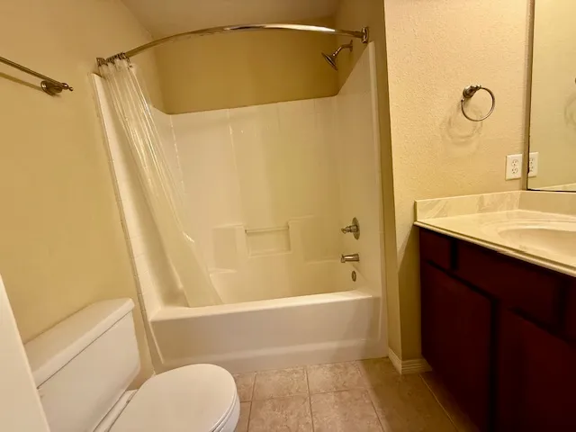 a bathroom with a shower curtain and a sink