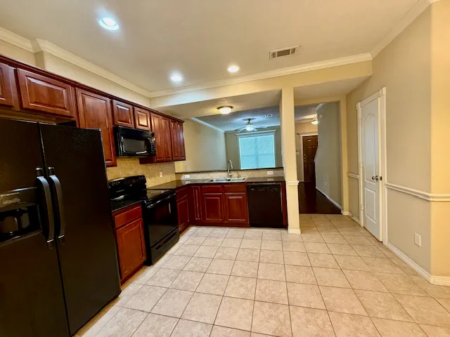 a large kitchen with a large counter top appliances and cabinets