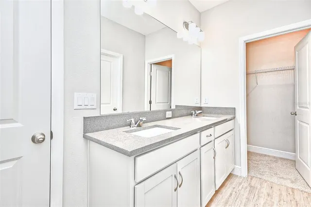 a bathroom with a double vanity sink and a mirror