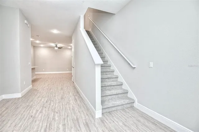 a kitchen with a white cabinets appliances and a wooden floor