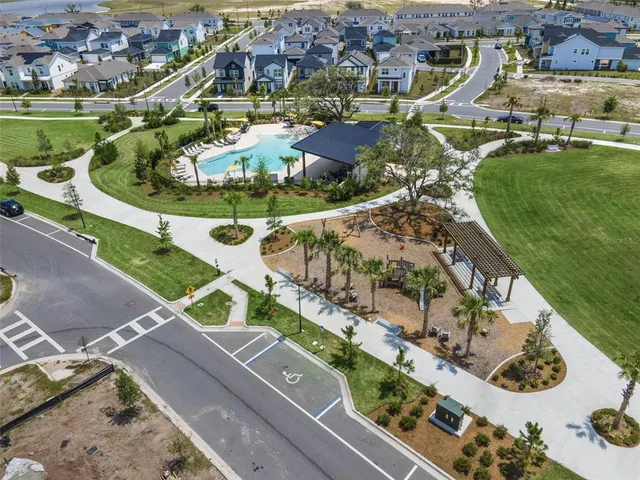 an aerial view of a house with a garden and lake view