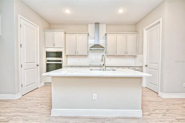 a kitchen with a sink a stove and cabinets