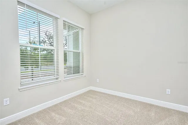 an empty room with windows and closet