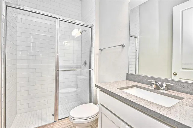 an empty room with cabinet and mirrors