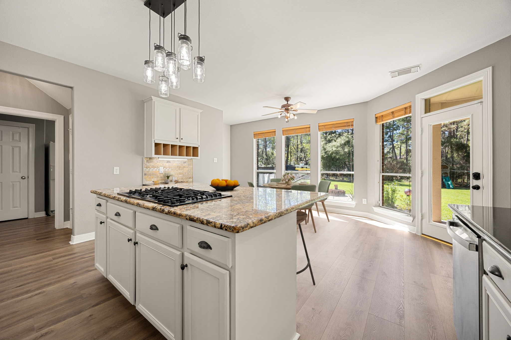 14419 Timbergreen Drive Magnolia, TX 77355 - Photo 9 of 43 Beautiful kitchen with oversized island, granite countertops, and a sunny breakfast area with backyard views. Large windows fill the space with natural light, making this kitchen both functional and inviting. *virtually staged*