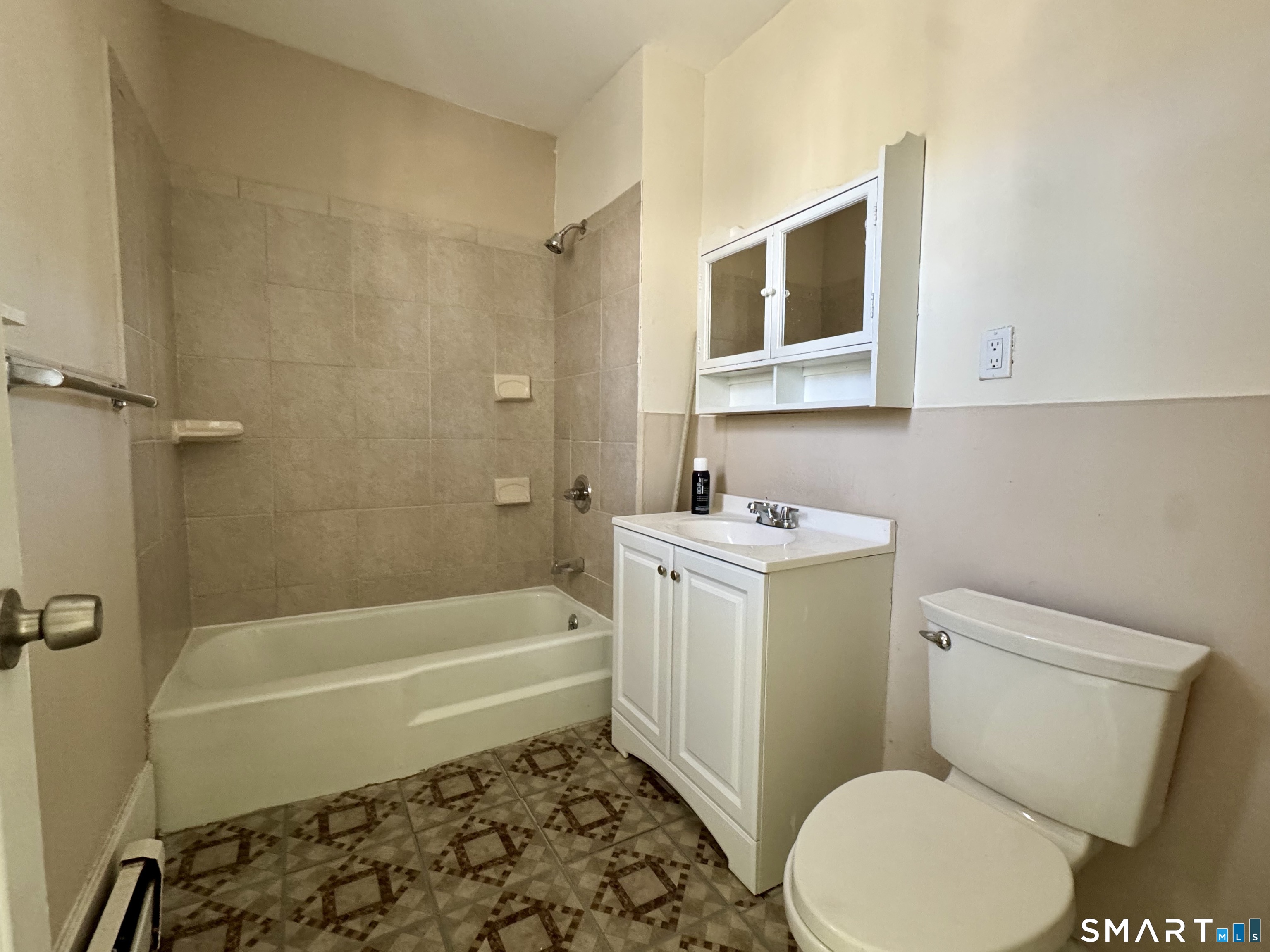 182 Sheridan Street, Unit 2 Bridgeport, CT 06610 - Photo 4 of 9 a bathroom with a toilet sink and bathtub