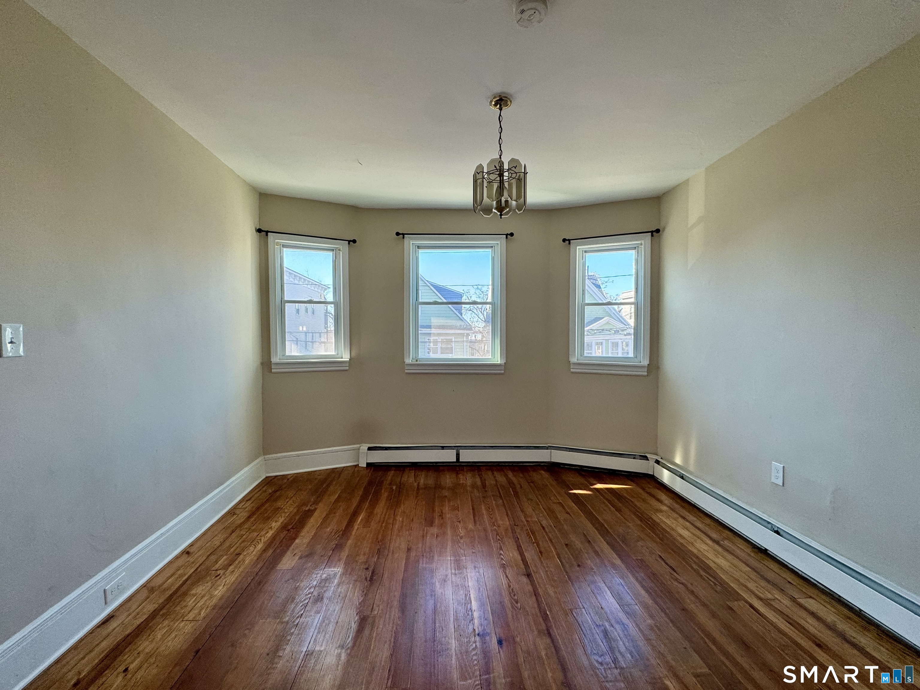 182 Sheridan Street, Unit 2 Bridgeport, CT 06610 - Photo 7 of 9 a view of empty room with wooden floor and fan