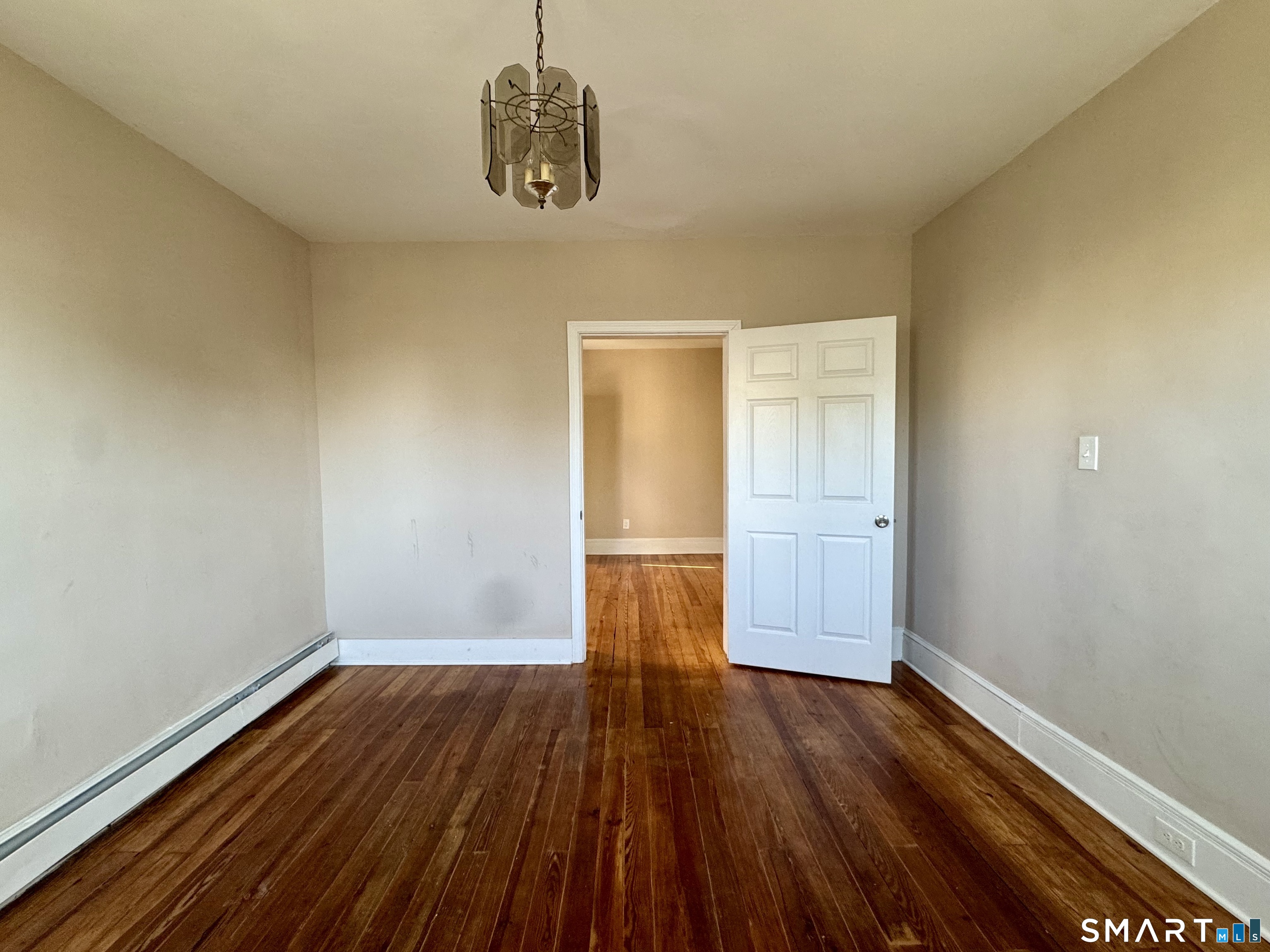 182 Sheridan Street, Unit 2 Bridgeport, CT 06610 - Photo 8 of 9 a view of empty room with wooden floor