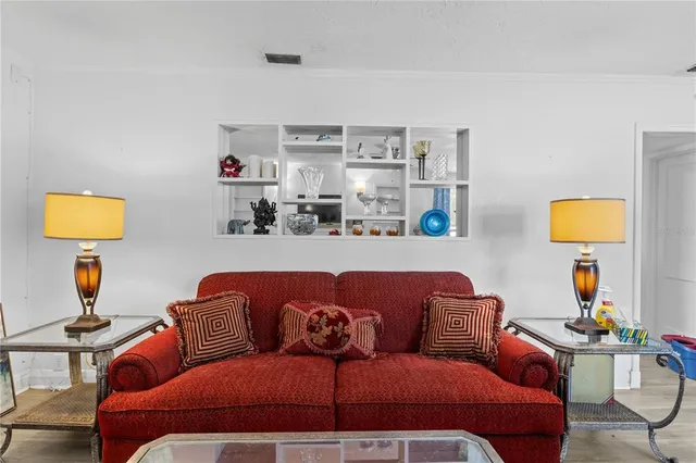 a living room with furniture and painting on the wall