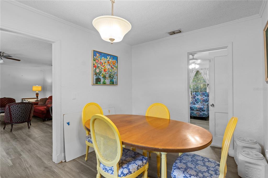1110 27th Avenue West Bradenton, FL 34205 - Photo 15 of 28 a view of a dining room with furniture and wooden floor