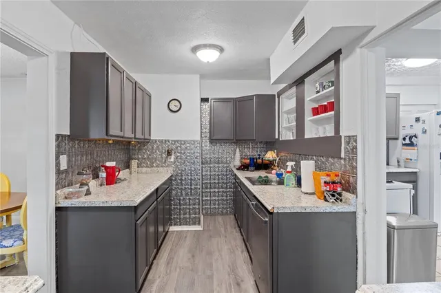 a kitchen with stainless steel appliances a sink and cabinets
