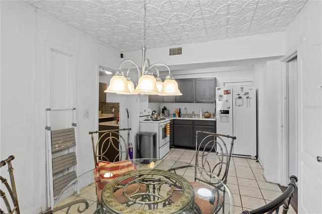 a view of a dining room with furniture a chandelier and wooden floor