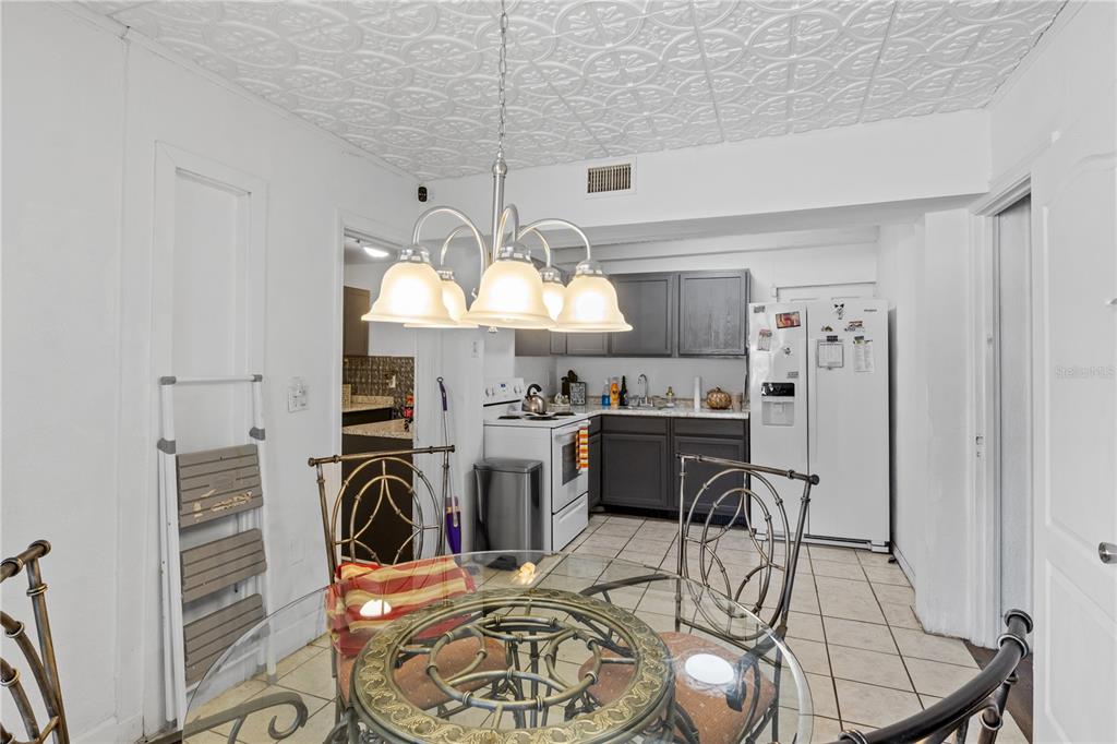 1110 27th Avenue West Bradenton, FL 34205 - Photo 21 of 28 a view of a dining room with furniture a chandelier and wooden floor