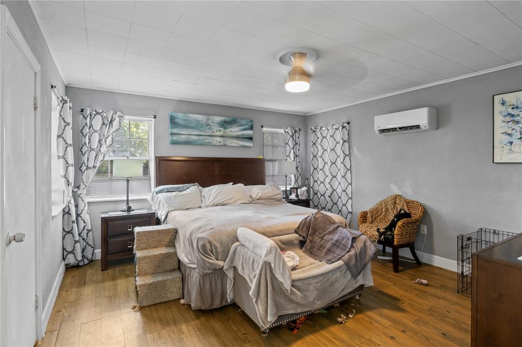 1110 27th Avenue West Bradenton, FL 34205 - Photo 24 of 28 a bedroom with a bed and wooden floor