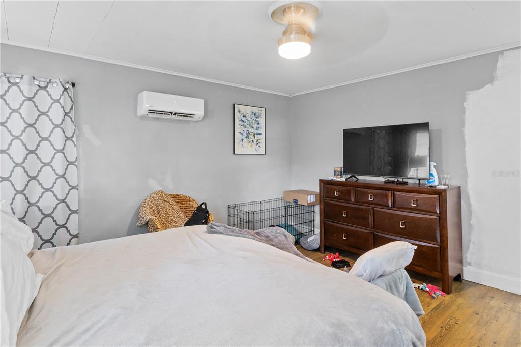 1110 27th Avenue West Bradenton, FL 34205 - Photo 25 of 28 a bedroom with a bed and a flat screen tv