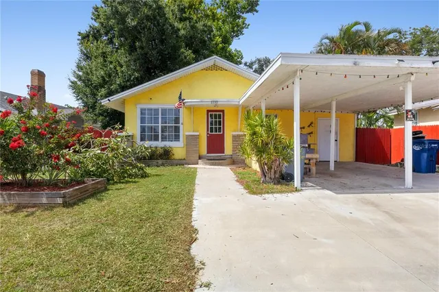 a view of a house with backyard and sitting area