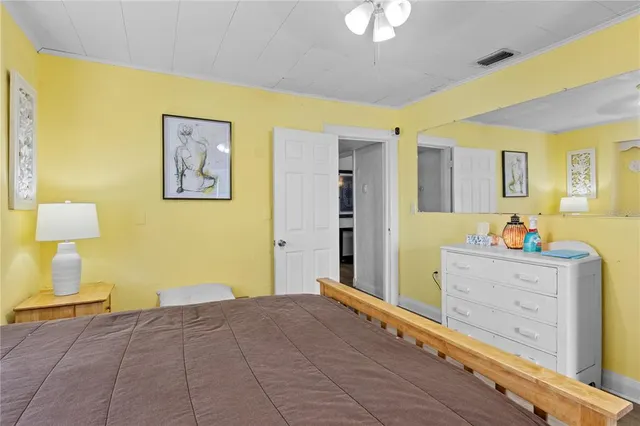 a bedroom with a bed and dresser with mirror