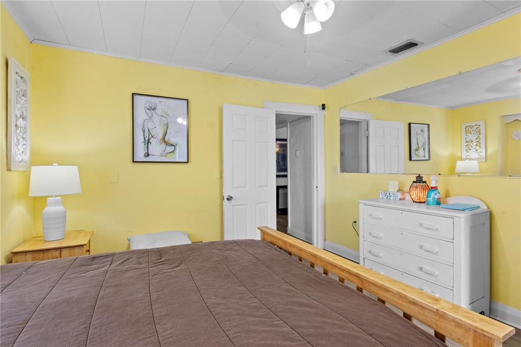 1110 27th Avenue West Bradenton, FL 34205 - Photo 5 of 28 a bedroom with a bed and dresser with mirror