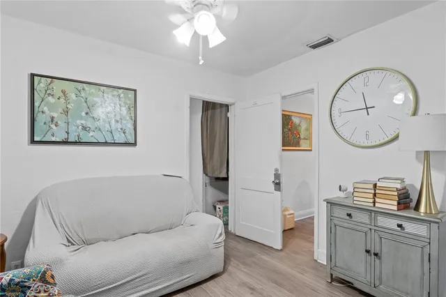 a living room with furniture a mirror and a window