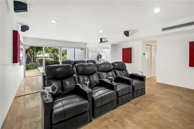 a living room with furniture a large window and a flat screen tv