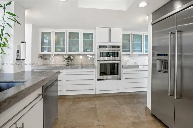a kitchen with stainless steel appliances cabinets and a counter top space