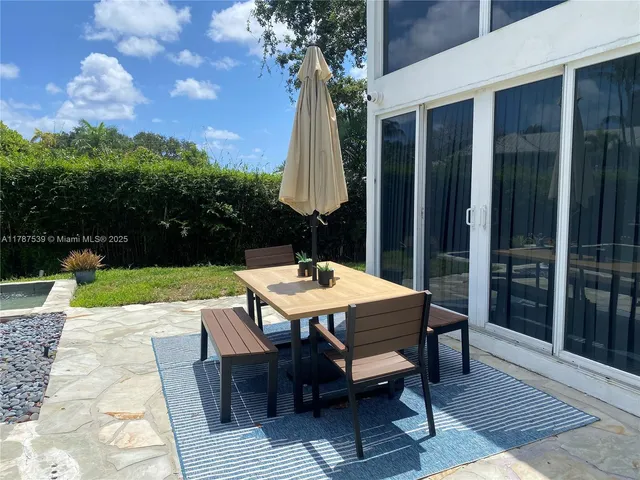 a view of a patio with a table chairs and a table