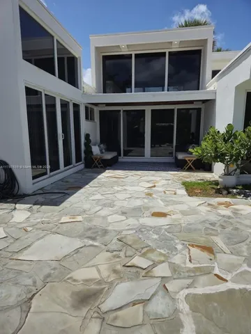 a view of a brick house with a yard