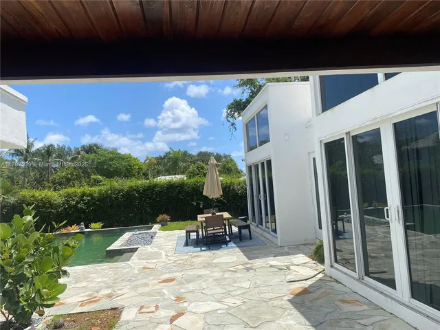 a view of swimming pool with seating space and fir pit