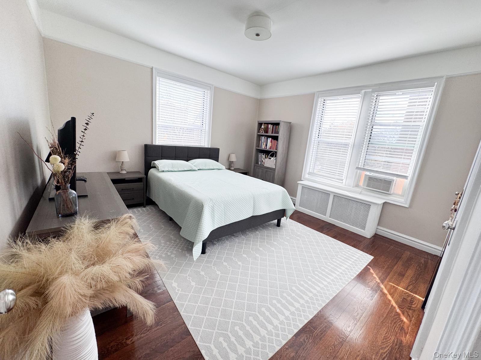 1470 Midland Avenue, Unit 3M Bronxville, NY 10708 - Photo 16 of 20 Bedroom featuring rich wood-finish flooring, multiple windows with blinds, and white trim throughout