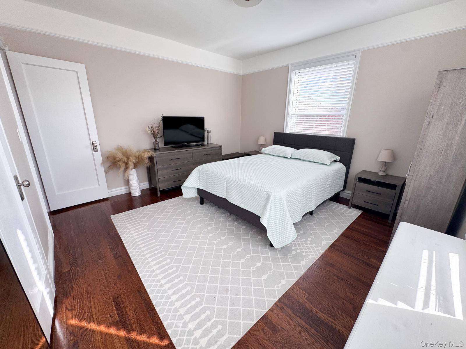 1470 Midland Avenue, Unit 3M Bronxville, NY 10708 - Photo 17 of 20 Interior bedroom featuring wood-finish flooring, white trim, and a window with blinds