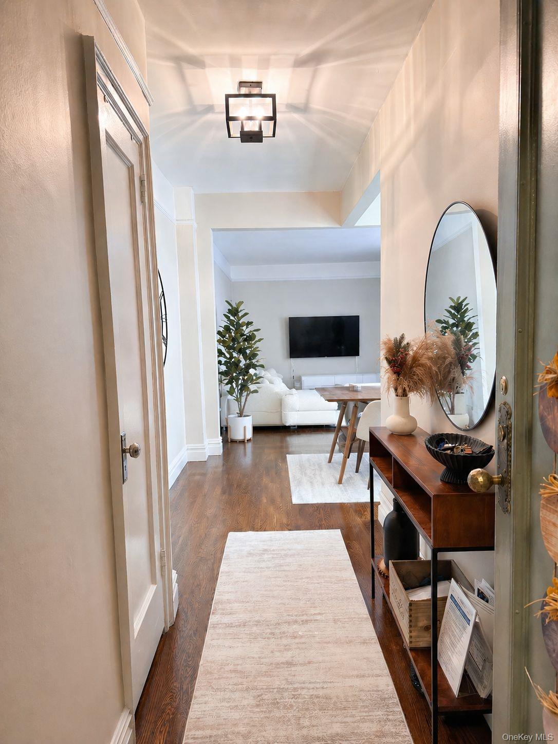1470 Midland Avenue, Unit 3M Bronxville, NY 10708 - Photo 4 of 20 Entry hall featuring wood-finish flooring, white baseboards, a modern ceiling light fixture, and a solid core door