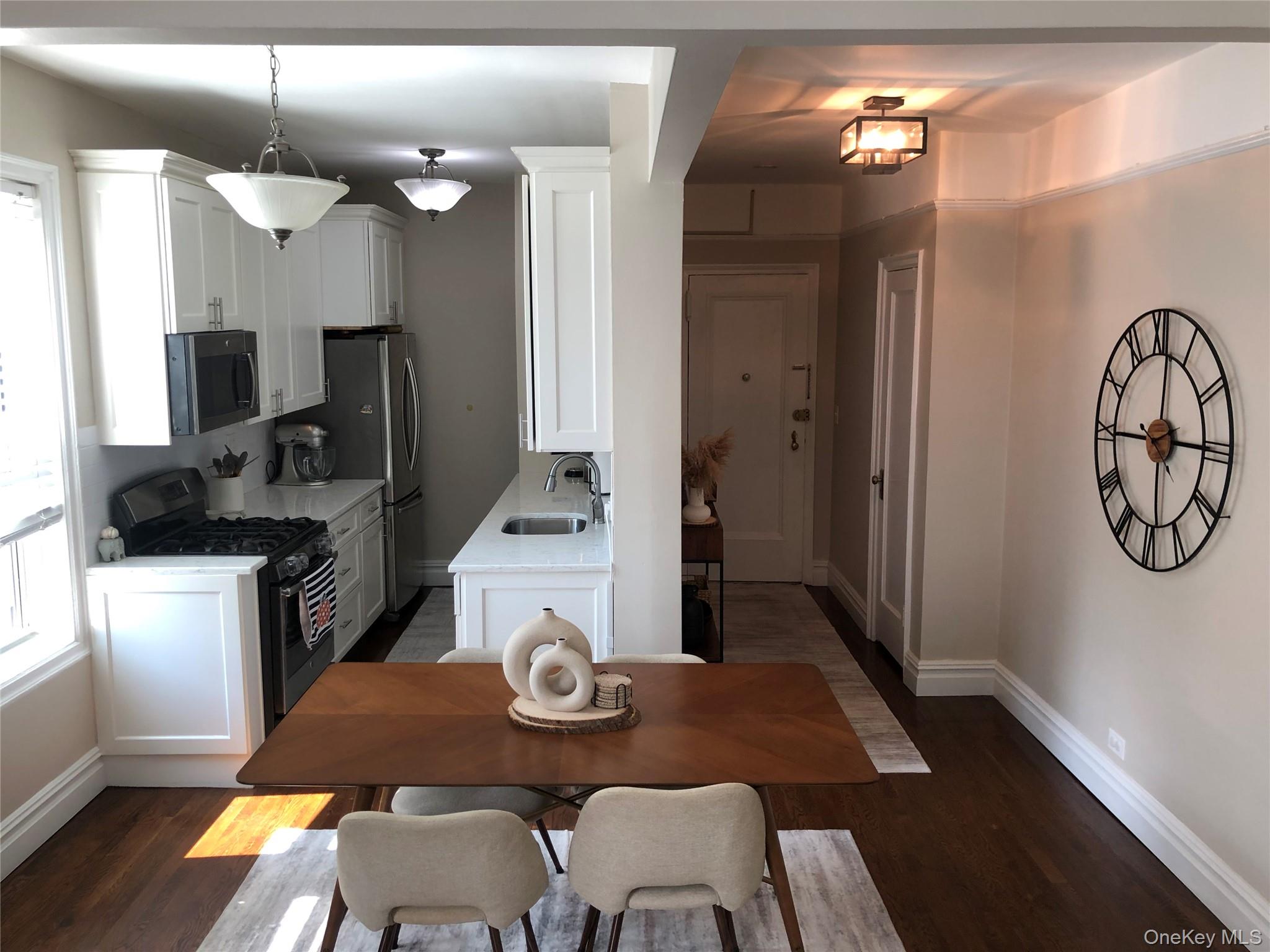 1470 Midland Avenue, Unit 3M Bronxville, NY 10708 - Photo 6 of 20 Renovated kitchen featuring white cabinetry, stainless steel appliances, and a gas range
