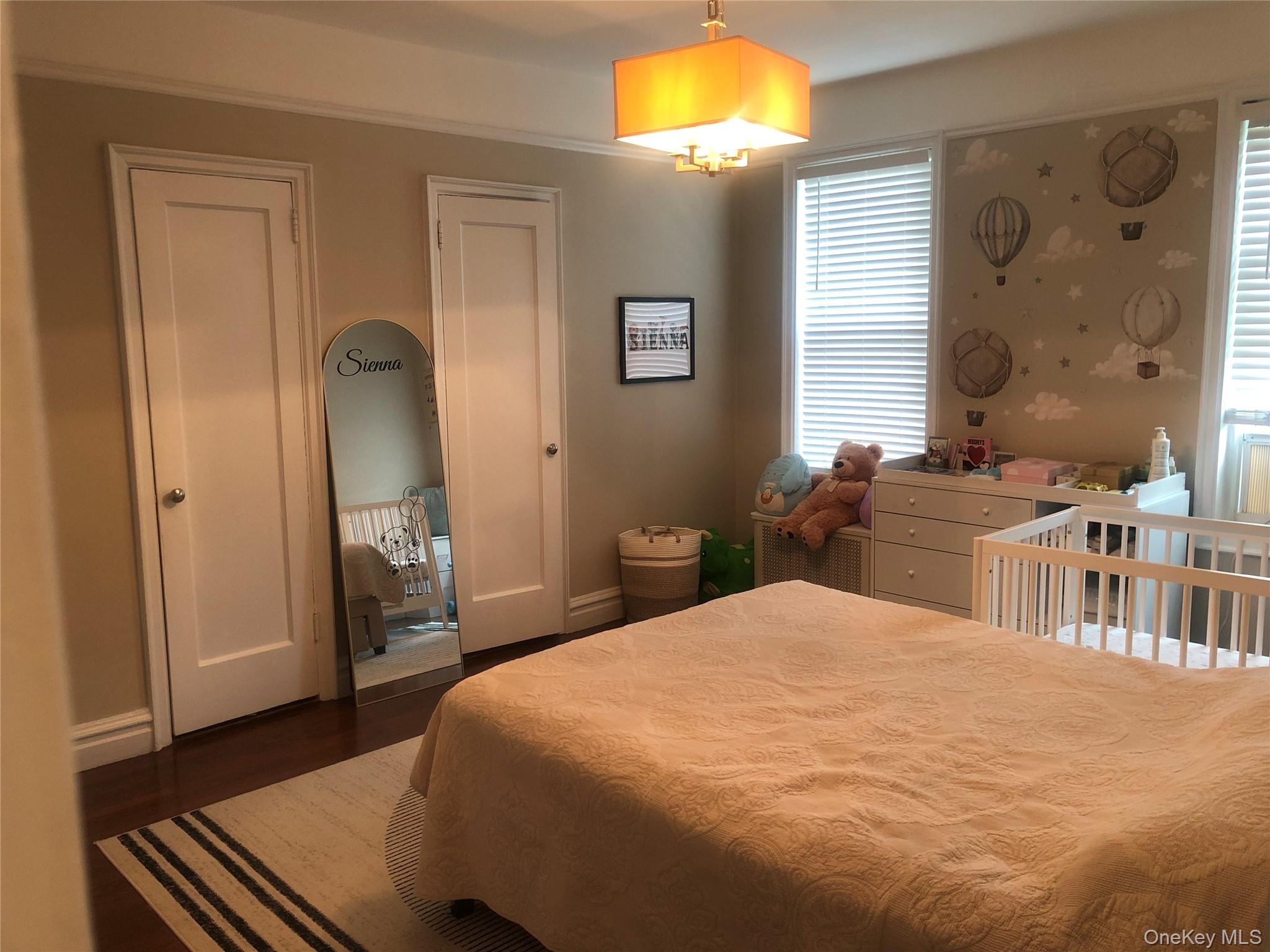 1470 Midland Avenue, Unit 3M Bronxville, NY 10708 - Photo 8 of 11 a bedroom with a bed and a chandelier