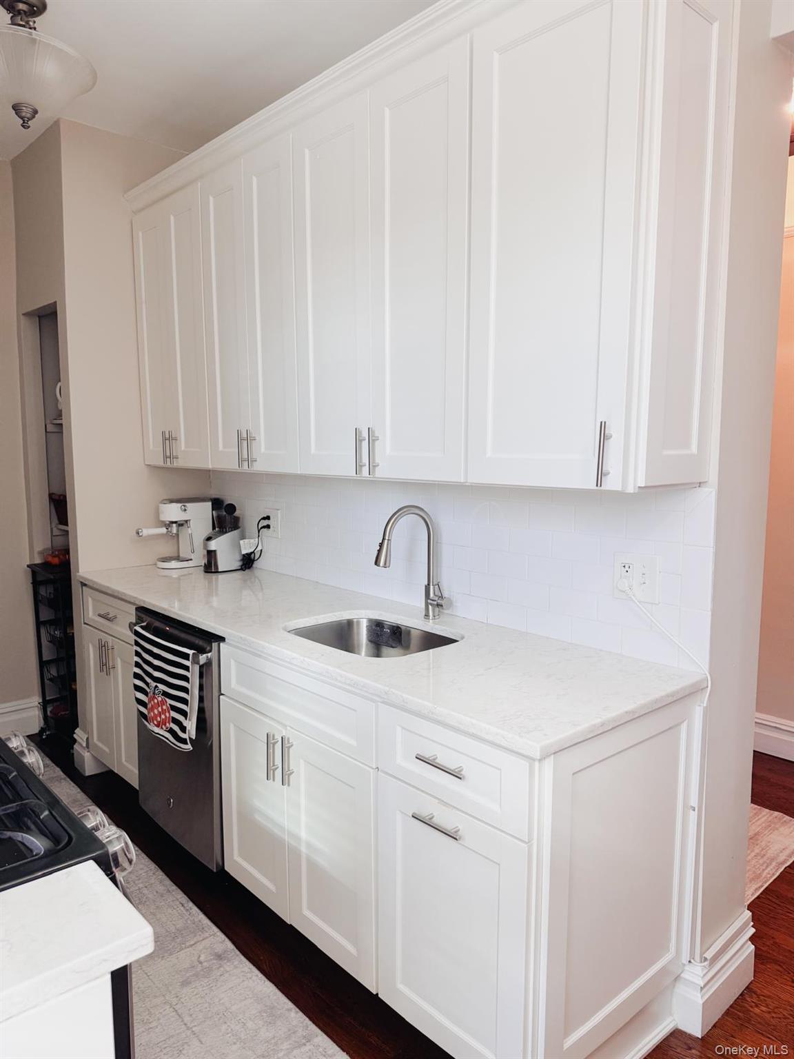 1470 Midland Avenue, Unit 3M Bronxville, NY 10708 - Photo 10 of 20 Kitchen featuring shaker-style cabinetry, undermount stainless steel sink, subway tile backsplash, and stainless steel dishwasher