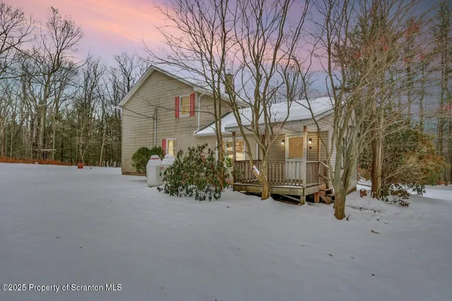 a view of a house with snow on the road