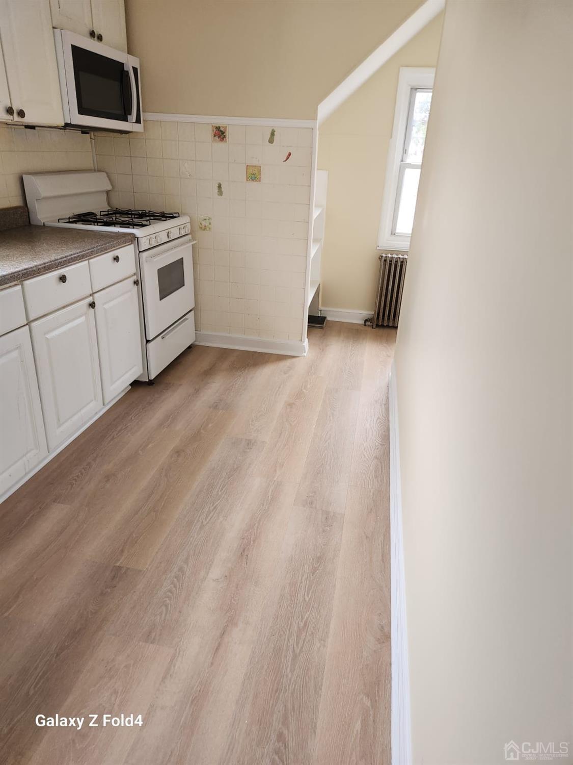 307 2nd Street Middlesex, NJ 08846 - Photo 6 of 8 a kitchen with granite countertop a sink and a stove top oven
