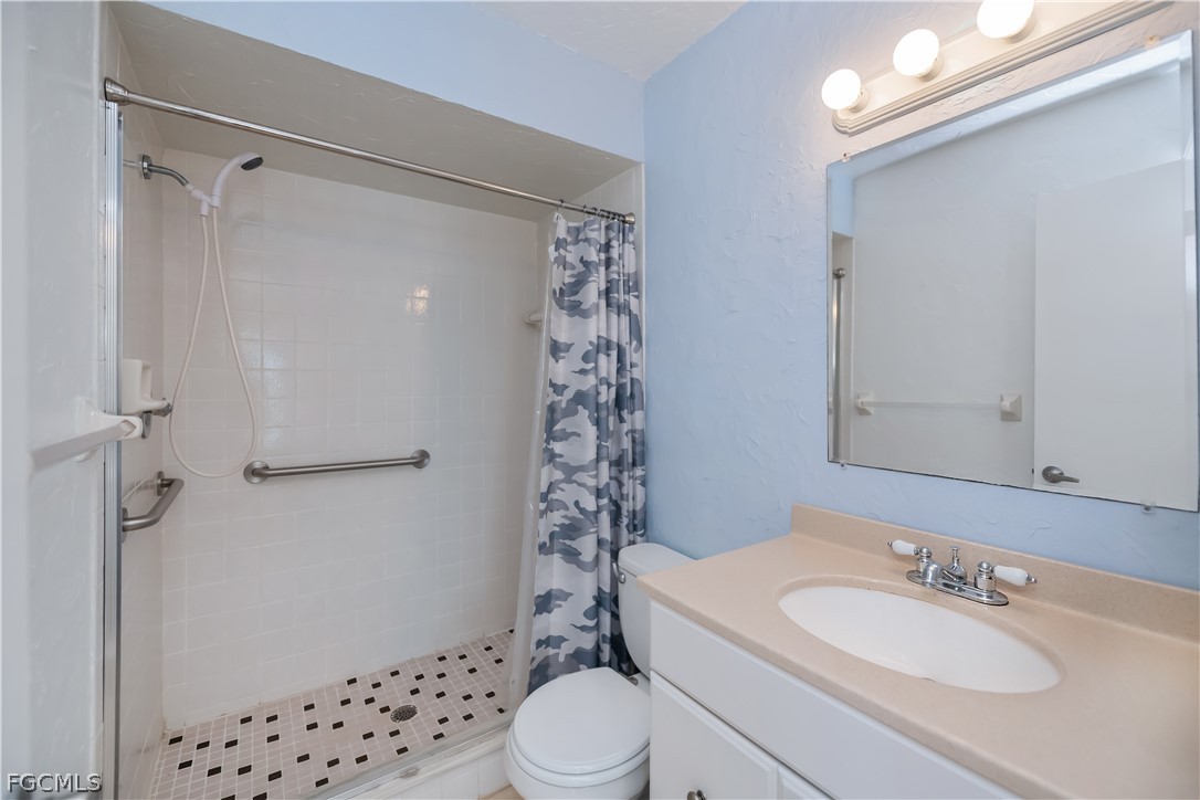 1100 Pondella Road, Unit 514 Cape Coral, FL 33909 - Photo 21 of 34 a bathroom with a sink a toilet and shower