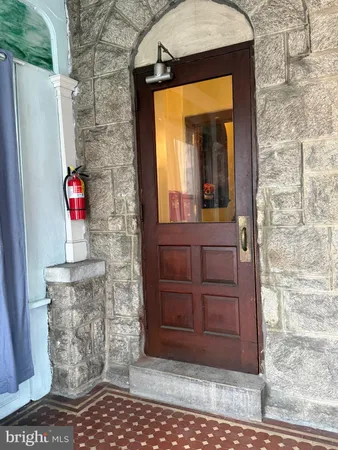 a view of a door and brick wall