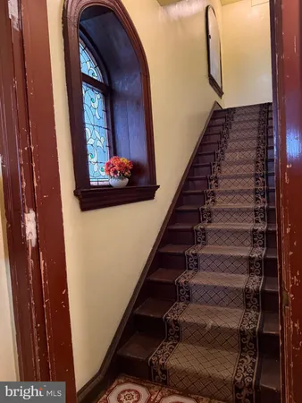 a view of staircase with wooden floor and stairs