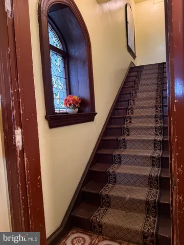 a view of staircase with wooden floor and stairs